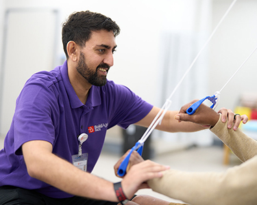 BoldAge PACE North Charleston, SC staff member assisting resident with physical therapy